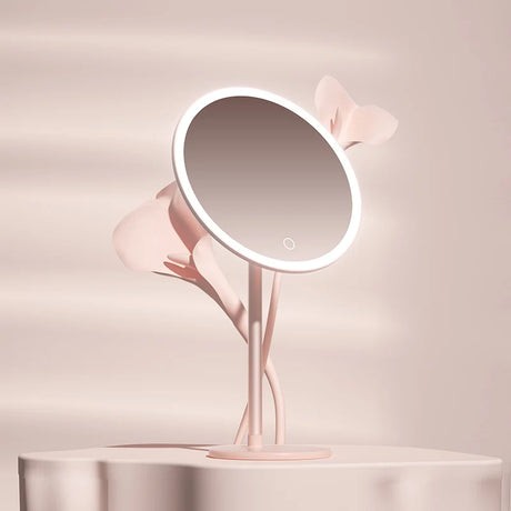 a pink lamp with a mirror on top