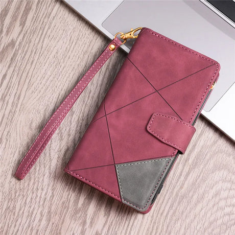 Pink leather wallet with geometric stitching and a gray accent patch.