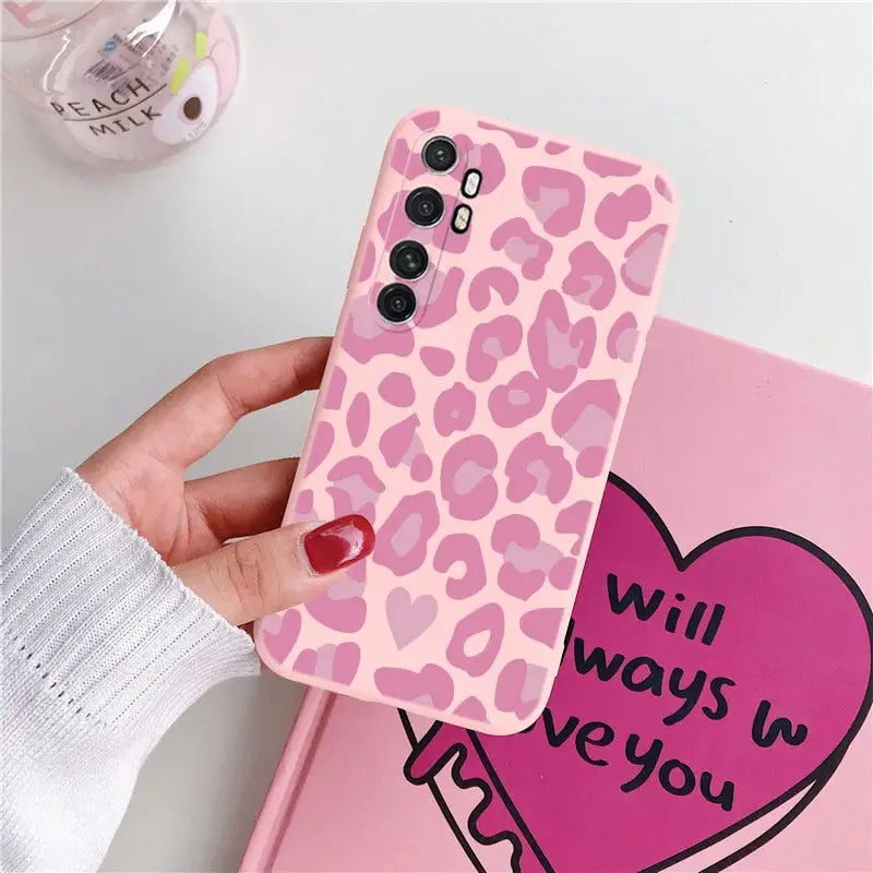 a pink leopard print phone case with a heart