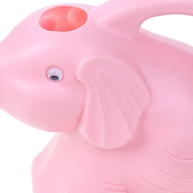 a pink elephant shaped toy with a red nose