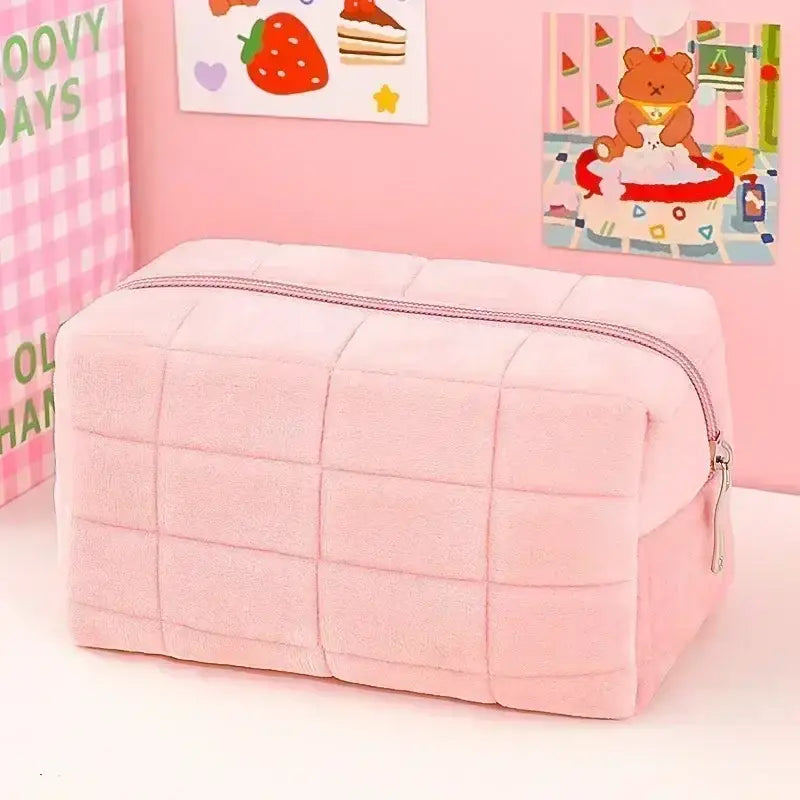a pink makeup bag with a teddy bear on it