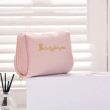 a pink makeup bag with the word be yourself on it