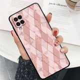 a woman holding a pink phone case with a pattern on it