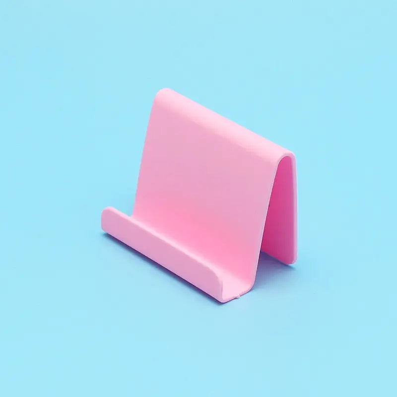 a pink paper holder on a blue background