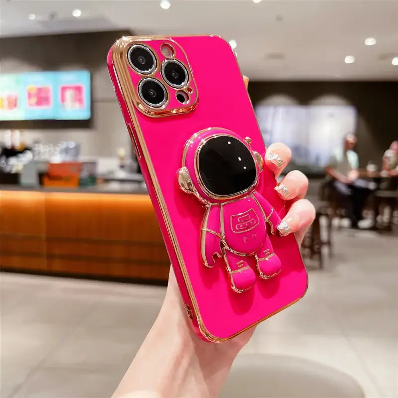 a pink phone case with a camera and sunglasses