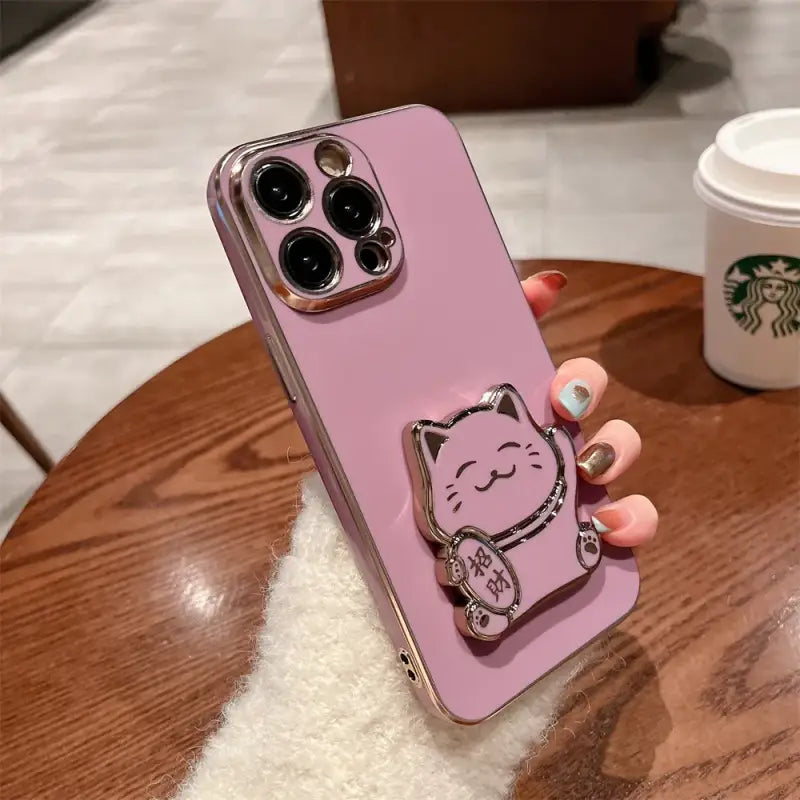 a pink phone case with a cat on it