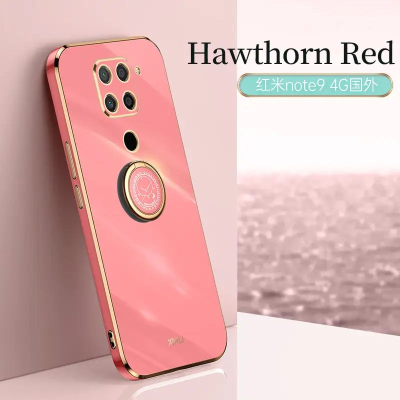 a pink phone with a gold ring on it