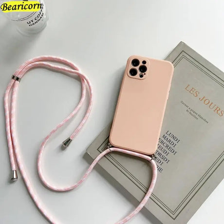 a pink phone case with a pink cord