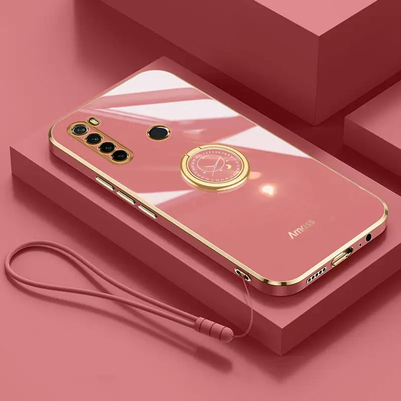 a pink phone case with a gold ring on it