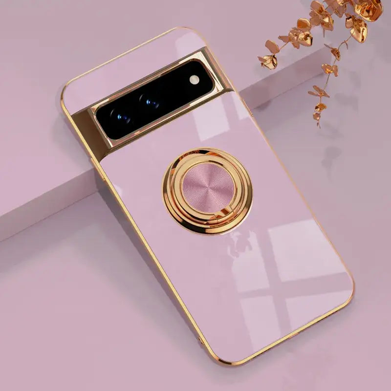 A pink phone case with a gold ring