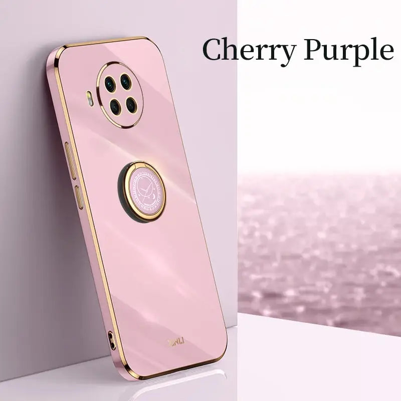 a pink phone case with a gold ring