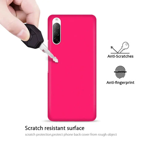 The back of a pink phone case with a hand holding a key