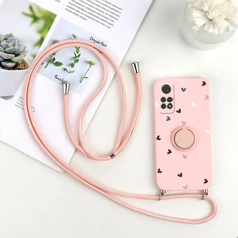 a pink phone case with a heart pattern on it
