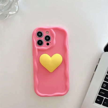 A pink phone case with a heart on it