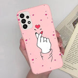 a pink phone case with a heart and a hand holding a finger