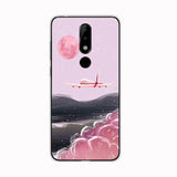 a pink phone case with a cartoon airplane flying over the mountains