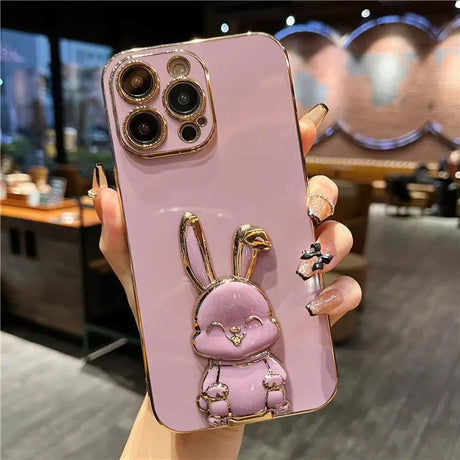 a pink phone case with a rabbit on it