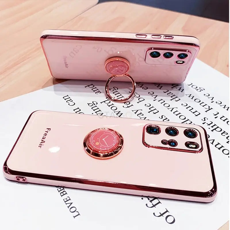a pink phone case with a ring on it