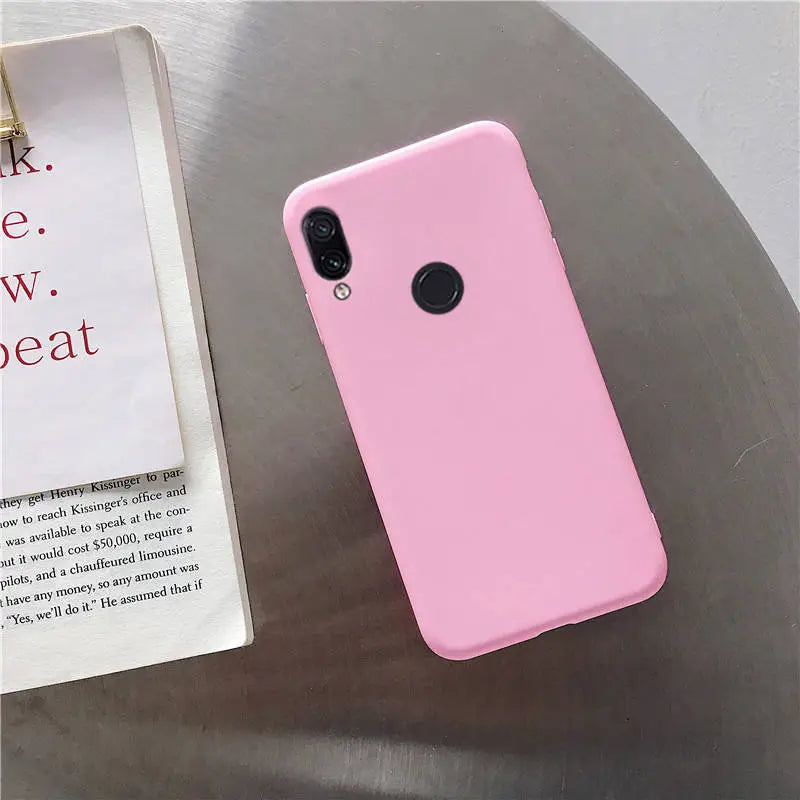 a pink phone case sitting on top of a table
