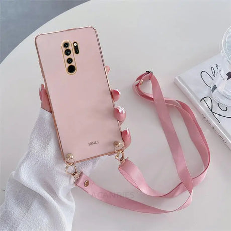 a pink phone case with a pink strap