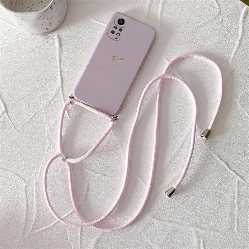 a pink phone with a pink strap on it