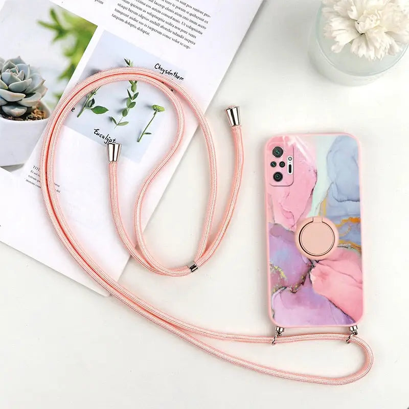 a pink phone case with a pink strap and a white flower