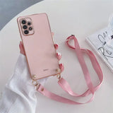 a pink phone case with a pink strap on a white table
