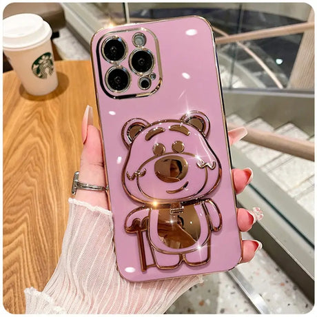 A pink phone case with a teddy bear on it