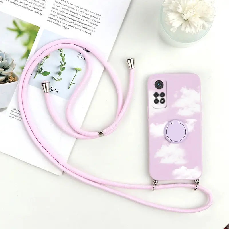 a pink phone case with a white cloud pattern