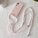 a pink phone case with a white strap