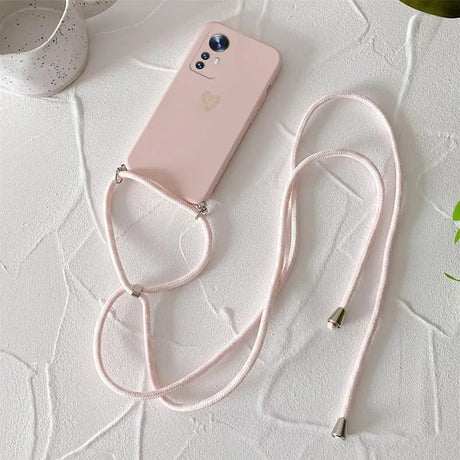 A pink phone case with a white strap