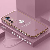 a pink phone case with a white maple leaf on it