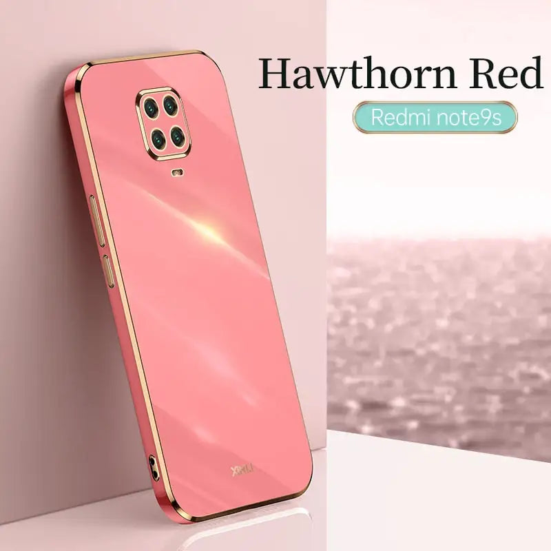 the back of a pink phone with a gold frame
