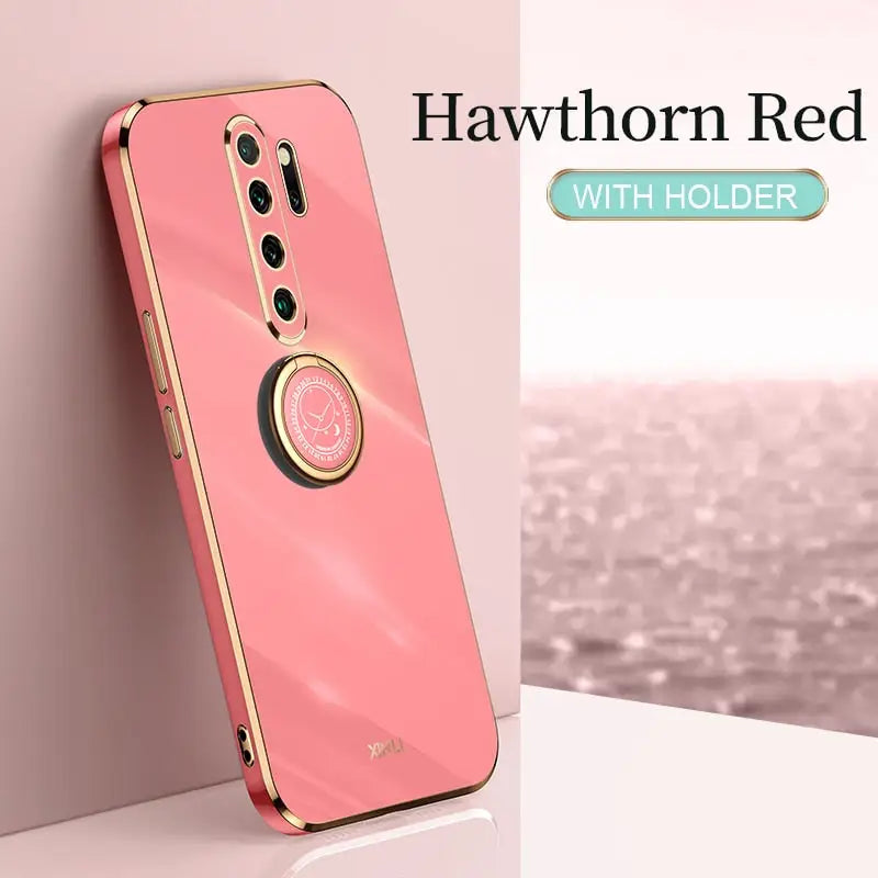 the back of a pink phone with a gold ring