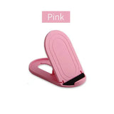 pink plastic phone holder with a black handle and a pink plastic clip