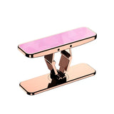 a pink phone stand with a phone on top