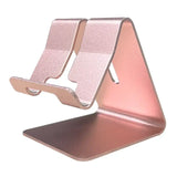 a pink phone stand with a phone on top