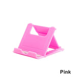 a pink phone stand with a white background