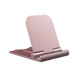 a pink phone stand with a white background