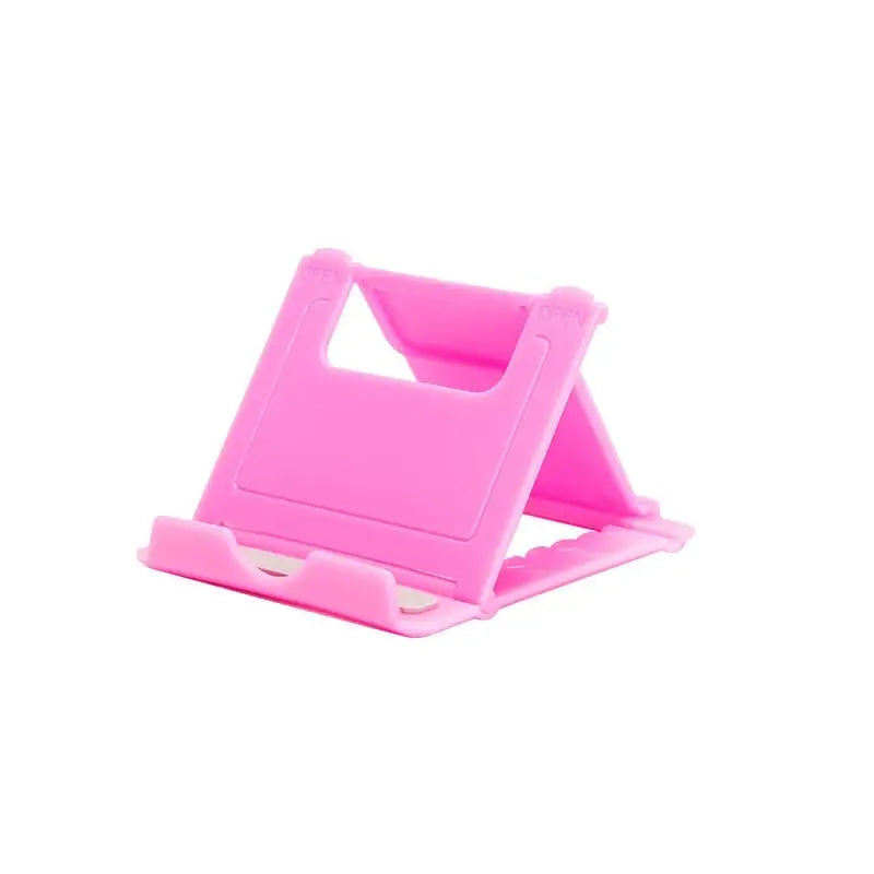 a pink phone stand with a white background