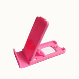a pink phone stand with a white background