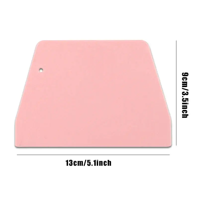 a pink plastic cutting board with a white background