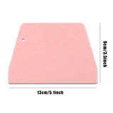 a pink plastic cutting board with a white background