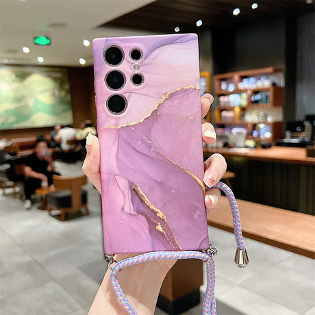 Pink and purple marbled phone case with multiple camera cutouts and a decorative cord.