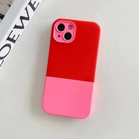 A pink and red phone case sitting on a white surface