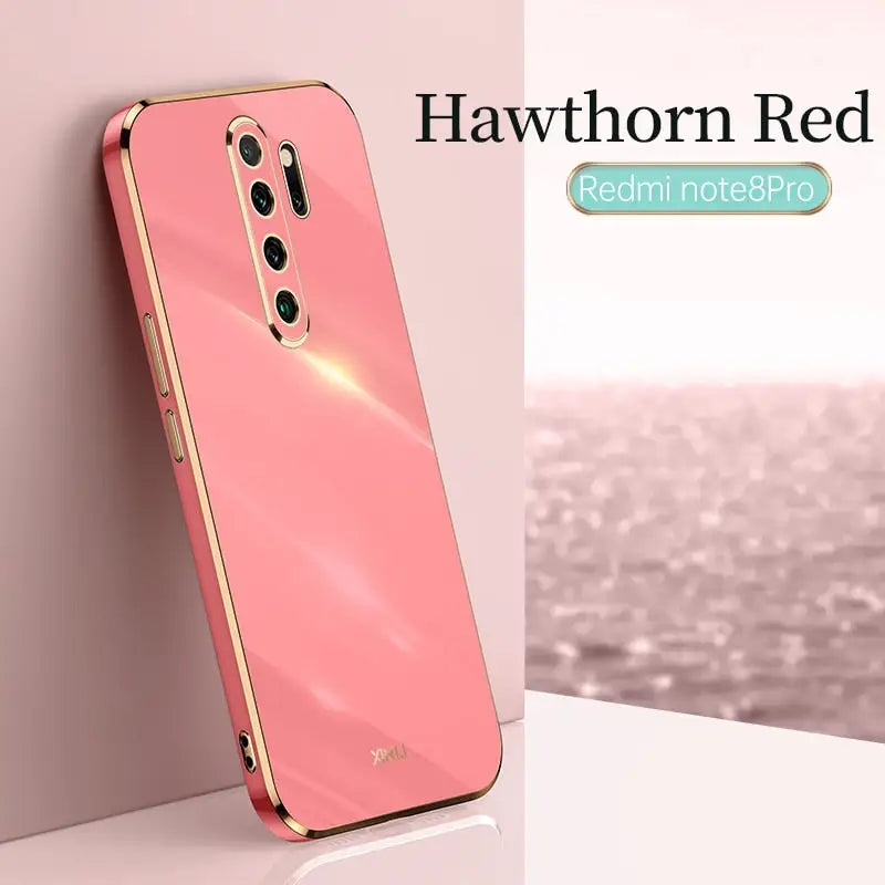 the back of a pink iphone case with a gold frame