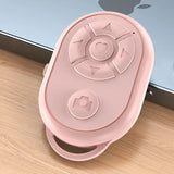 a pink remote control device on a wooden floor