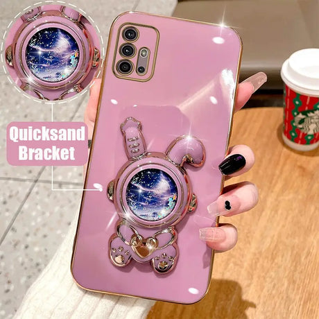 Someone holding a pink samsung galaxy case with a clock on it