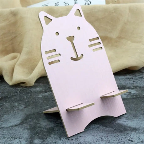 a pink cat shaped paper craft with a wooden stand