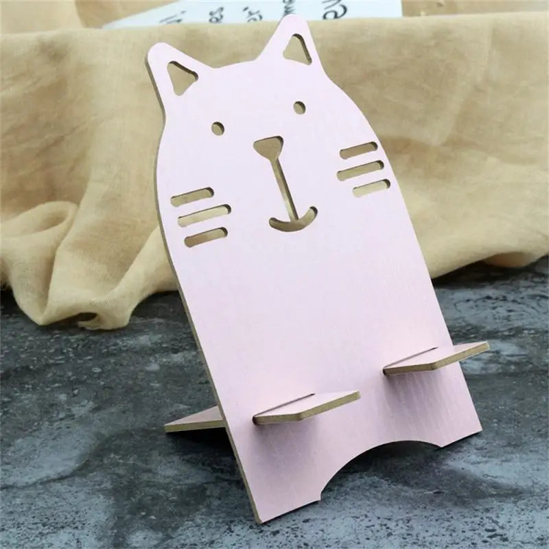 a pink cat shaped paper craft with a wooden stand